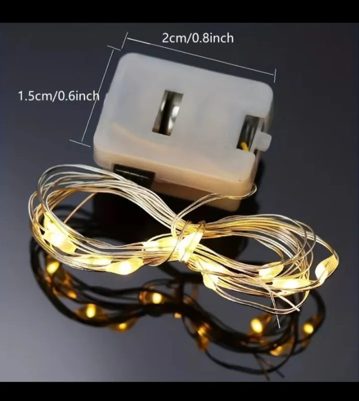 Luces LED hada con caja de pilas mostrando medidas 2cm x 1.5cm