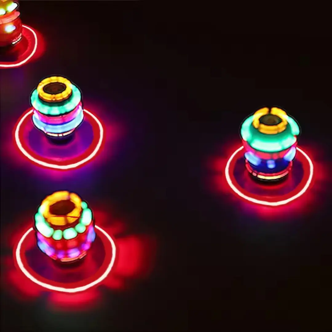 Varios trompos automáticos girando en la oscuridad con luces LED de colores